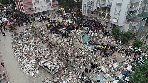 People search through rubble following an earthquake in Adana