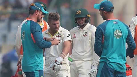 David Warner gets treatment after a blow on the elbow in Delhi.