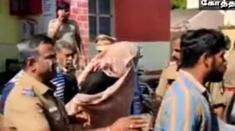 One of the accused in the murder escorted by the cops.