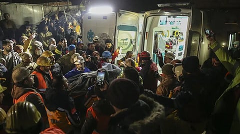 Rescue workers pull out a young woman from a collapsed building in Adiyaman, southern Turkey.