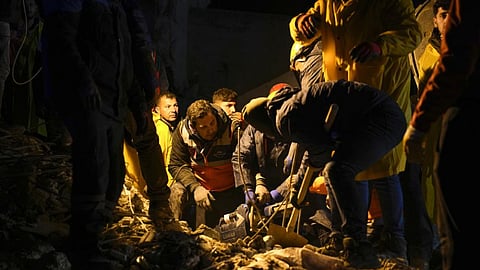 Emergency teams search in the rubble for people in a destroyed building in Adana, Turkey