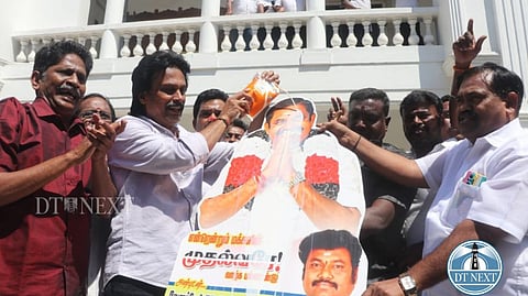 EPS supporters pouring milk on the cut-out of EPS.