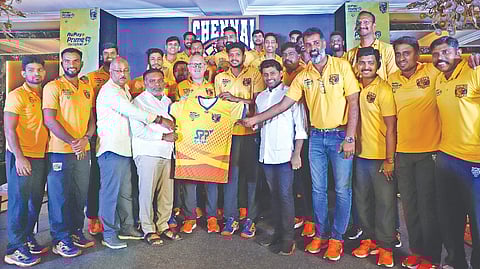 Chennai Blitz players, coaches, co-owners and management members pose with the new jersey