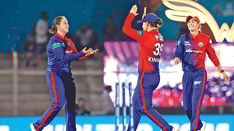 Alice Capsey (left) celebrates
the fall of a wicket.