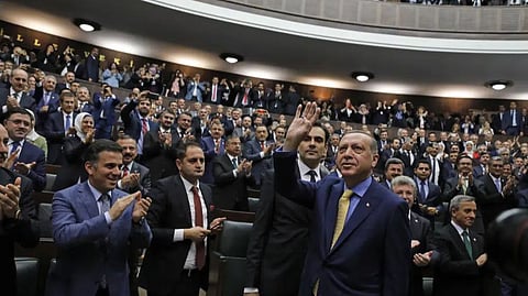 Turkey's President Recep Tayyip Erdogan waves to members of the ruling Justice and Development party.