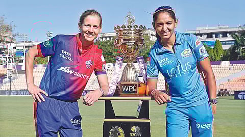 Rival captains Meg Lanning and Harmanpreet Kaur pose with the trophy.