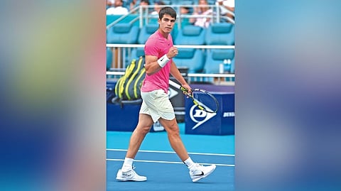 Carlos Alcaraz exults after winning.