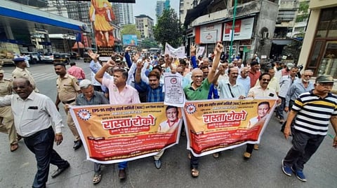 Maharashtra government employees raise slogans during a protest to demand restoration of the old pension scheme.