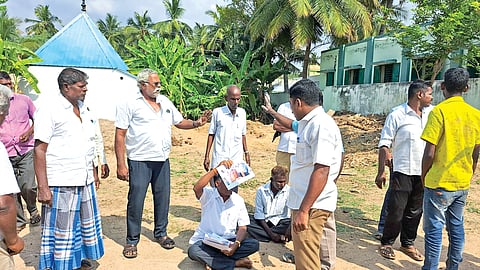 DMK men stage protest to prevent officials from measuring the land.