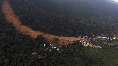 This aerial photo released by Indonesia's National Disaster Management Agency (BNPB) on Wednesday, March 8, 2023, shows a village affected by landslide on Serasan Island, Natuna regency, Indonesia.