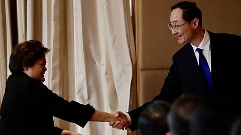 Department of Foreign Affairs Theresa Lazaro shakes hands with China's Vice Foreign Minister Sun Weidong