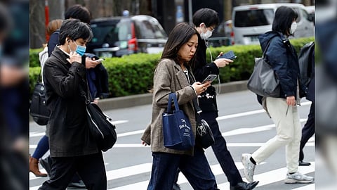 Commuters make their way on the first day of the Japanese government's relaxation of official guidance on masks as it emerges from the COVID-19 pandemic, in Tokyo, Japan March 13, 2023