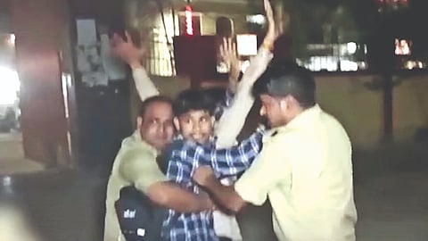 Attacker being apprehended by the police.