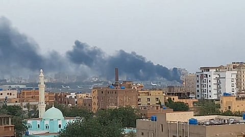 Smoke rises from the tarmac of Khartoum International Airport as a fire burns, in Khartoum