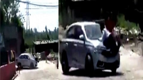 The car dragging the cop