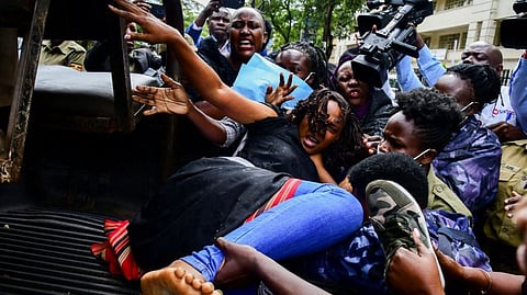 Ugandan riot police officers attempt to detain Masaka District Woman Member of Parliament Joan Namutaawe, as female opposition legislators participate in a protest to Ministry of Internal Affairs to deliver a petition over the brutality against them in Kampala, Uganda April 27, 2023.