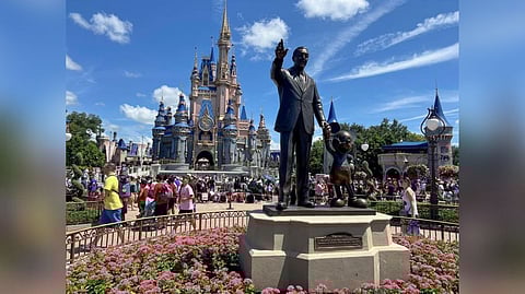 People gather at the Magic Kingdom theme park before the "Festival of Fantasy" parade at Walt Disney World in Orlando