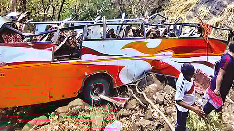 Mangled remains of the bus that fell into a gorge on Mumbai-Pune highway, in Raigad district on Saturday
