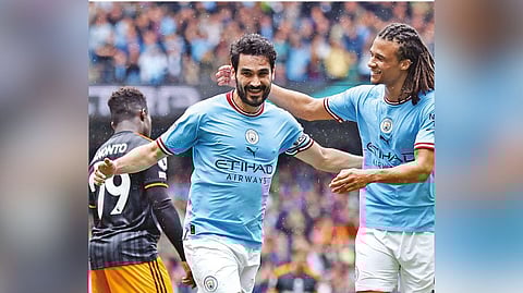 Ilkay Gundogan (left) celebrates scoring a goal with teammate Nathan Ake