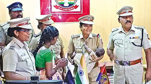 Railway police hand over the infant to mother Kalaiselvi in Egmore, Friday.