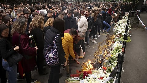 School children gather to light candles for the victims near the Vladislav Ribnikar school