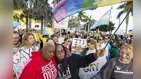 Florida House Representative Michele Rayner, left, hugs her spouse, Bianca Goolsby, during a march at city hall in St. Petersburg, Fla., on March 12, 2022, to protest the controversial "Don't Say Gay" bill passed by Florida's Republican-led legislature.