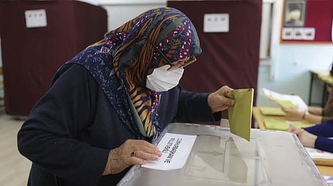 A woman votes at a polling station in Ankara, Turkey
