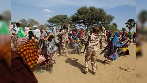 Sudanese women, who fled the violence in their country and who were waiting desperately for food distribution, dodge the soldiers attempting to hold them back as they tried to grab bags of provision when they saw that supplies brought by a Turkish aid group (IHH) were running out, near the border between Sudan and Chad in Koufroun, Chad May 7, 2023