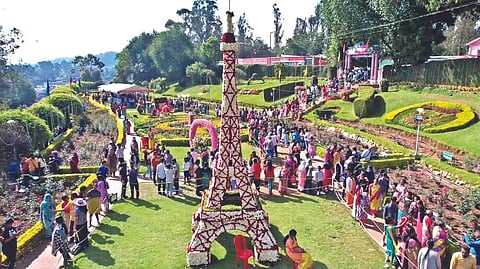 Tourists enjoying a floral display of Eiffel Tower in the annual Rose Show at Ooty on Tuesday