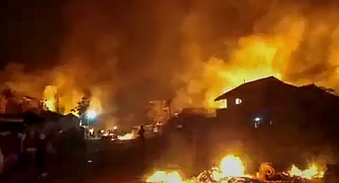 Flames rise from structures lit on fire after violence broke out
