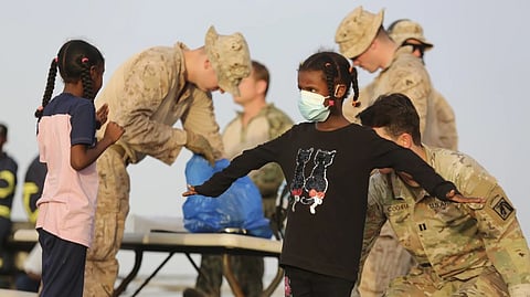 American nationals are searched by the U.S. soldiers before boarding a ship in Port Sudan