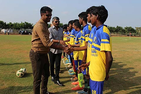 Raman Vijayan (left) greets the football players
