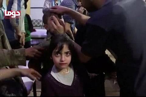 A girl looks on following alleged chemical weapons attack, in what is said to be Douma, Syria