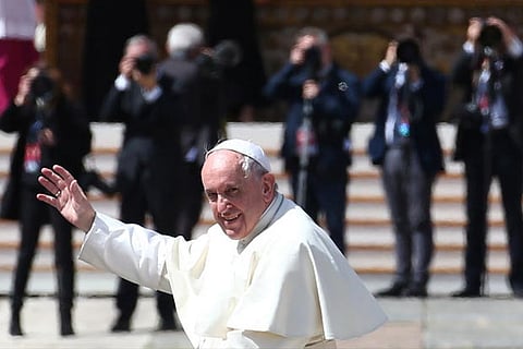 Pope Francis waves as he leaves at the end of a Holy Mass to mark the feast of Divine Mercy