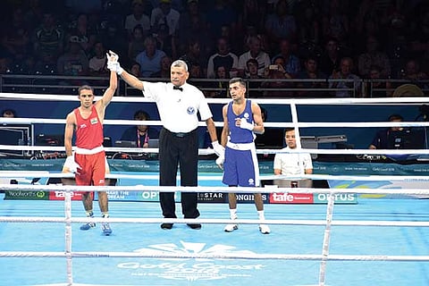 Amit Panghal (red) was assured of a medal in his debut CWG