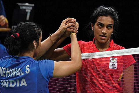 PV Sindhu (right) shakes hands with Saina Nehwal after losing out on a gold medal