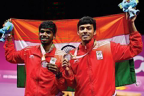Satwik Rankireddy (left) and Chirag Shetty hold the Indian flag