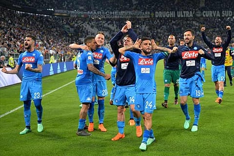 Napoli's Lorenzo Insigne celebrates after the match with teammates and fans