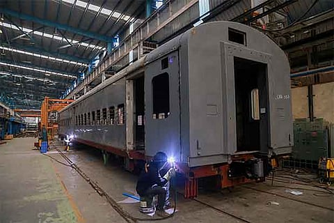 ICF workers busy completeing a train