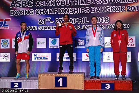 Nitu (centre) on the podium with her gold medal in Bangkok