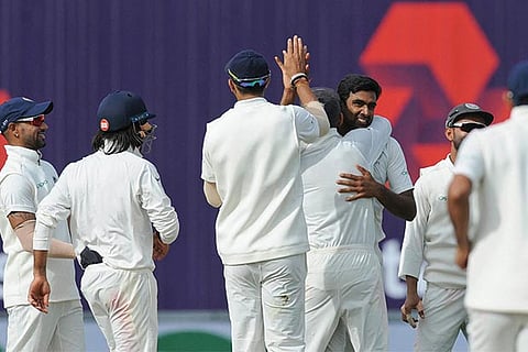 India's Ravichandran Ashwin, celebrates with teammates the dismissal of England's Jos Buttler