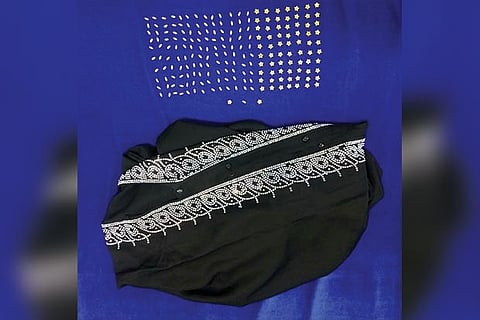 Customs officials seized the overcoat which had buttons and stones made of gold