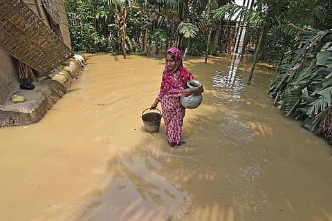 A woman carries drinking water at a flood affected area in Assam.(File photo)