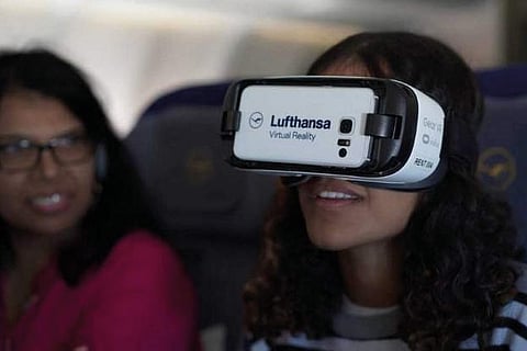 A Lufthansa passenger wears special goggles to enable a virtual reality experience