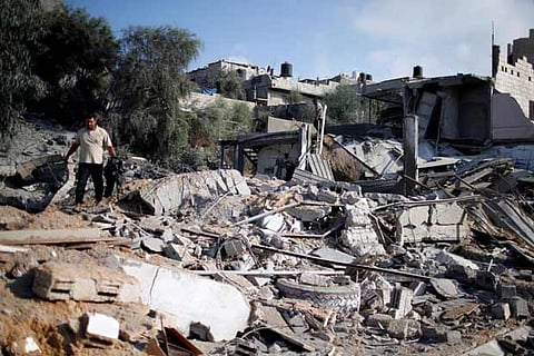 A Palestinian man inspects a Hamas site that was hit in an Israeli air strike