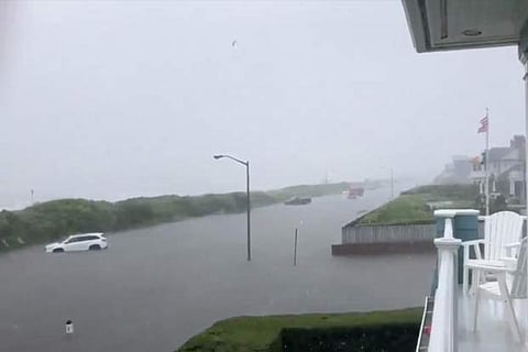 A road is submereged in flood water after heavy rains in Spring Lake, New Jersey