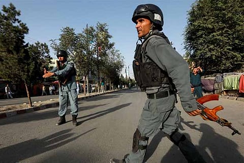 Afghan policemen arrive at the site of a suicide bomb attack in Kabul