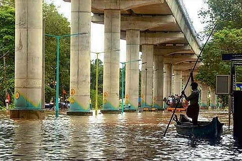 A man sails his boat at a flooded locality of Aluva in Kochi.(PTI)