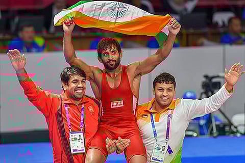 India's Bajrang Punia carries the tricolour after winning in the Finals of men's freestyle wrestling