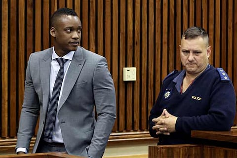 A police officer looks on as Duduzane Zuma, a son of former SA President Jacob Zuma